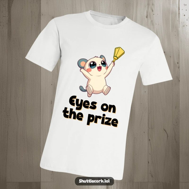 Funny t-shirt: a creature with big, round eyes jumps high in the air, reaching for a shuttlecock with eagerness.