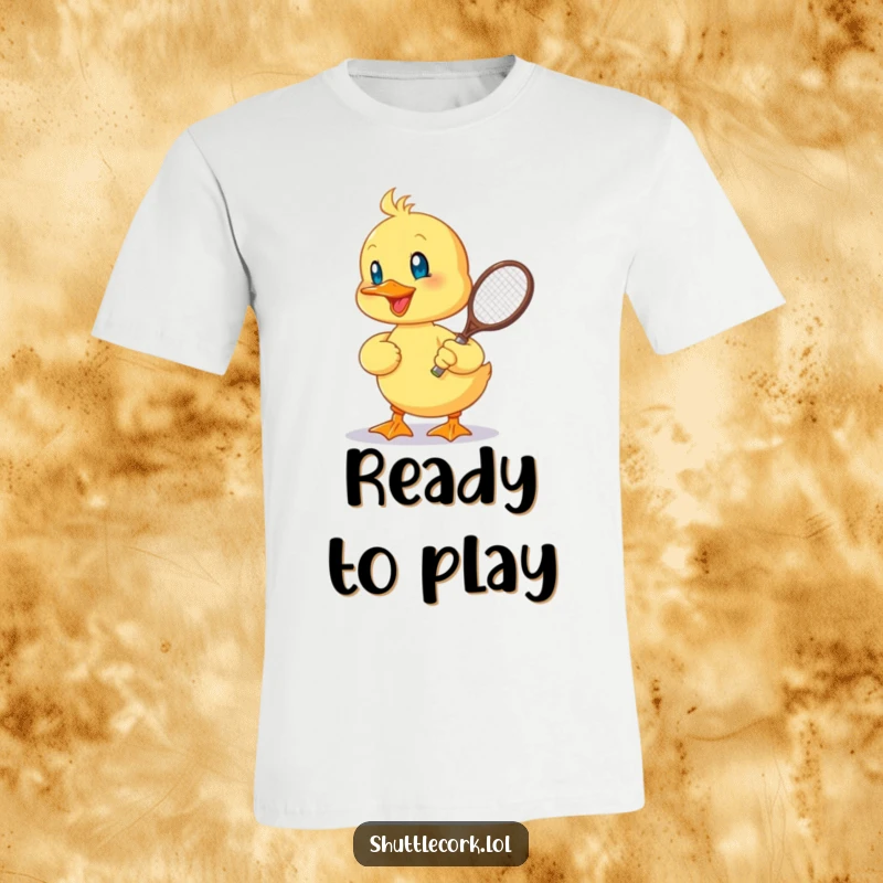 Funny t-shirt depicting a cheerful duckling energetically hitting a shuttlecock with a tiny racquet, celebrating playful competition.